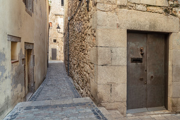 Narrow medieval street in Girona. Girona's typical narrow street in a medieval village in Northern Catalonia