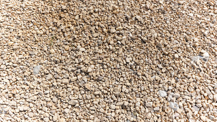 Close up to small stones and rocks grey color shot at the bright day