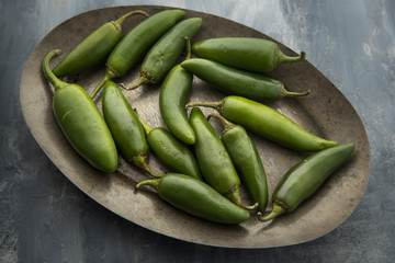 Overview of green peppers on a platter.