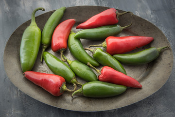 Mixed red and green peppers on a platter.
