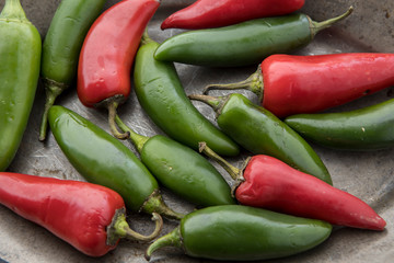 Red and green chili peppers on a platter.