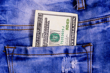 American twenty dollars banknote in a pocket of blue jeans