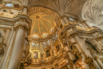Fototapeta na wymiar Magnificent golden dome inside the Granada Cathedral in Spain. Interior decoration found in the Granada Royal Cathedral