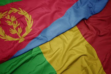 waving colorful flag of mali and national flag of eritrea.