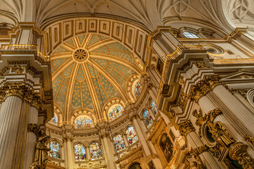 Magnificent golden dome inside the Granada Cathedral in Spain. Interior decoration found in the...