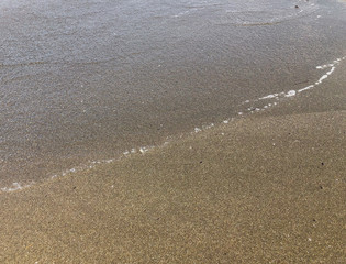Close up of sandy beach. Summer sunny day, water background