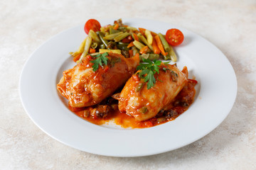 Stuffed squid with tomato sauce and vegetables