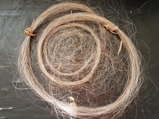 horse hair in a circle on a black table