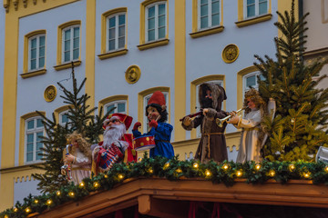 santa claus at the roof of a market stand at the christkindlmarkt in rosenheim, bavaria