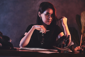 Young attractive girl is working on her new project with puppets.