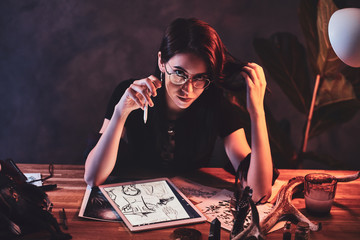 Young attractive girl is working on her new project with puppets.