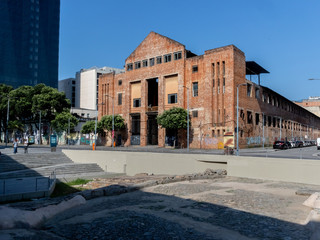 Fototapeta premium Old brick building, abandoned, in front of Cais do Valongo, downtown Rio de Janeiro, Brazil