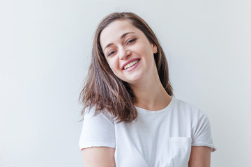 Happy girl smiling. Beauty portrait young happy positive laughing brunette woman on white background isolated. European woman. Positive human emotion facial expression body language