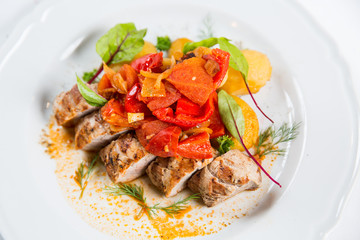 Roasted pork fillet with vegetables on a plate