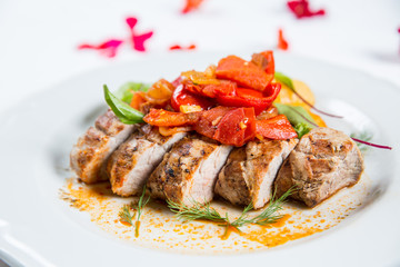 Roasted pork fillet with vegetables on a plate