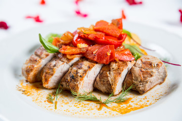 Roasted pork fillet with vegetables on a plate