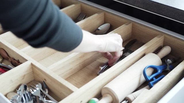 pulling the cutlery out of the cutlery drawer
