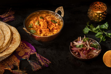 Indian cottage cheese with flat breads served in copper bowl