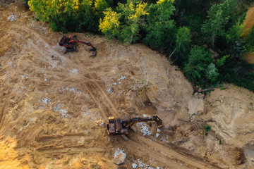 Dump excavators on city dump yard, aerial view
