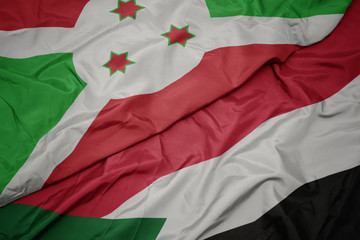 waving colorful flag of sudan and national flag of burundi .