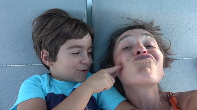 4K Portrait selfie Child kissing his mothers cheek several times