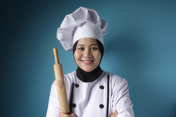 Fototapeta premium Asian Woman Chef, Baker Holding Kitchen Tools