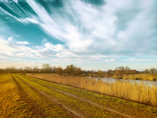 Obraz premium Country dirt road and blue sky