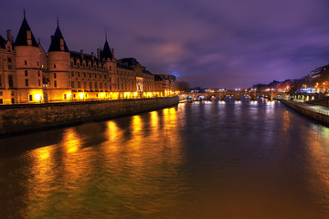 Night view of Conciergerie and Seine river in Paris 