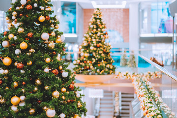 Christmas trees with red and golden decoration in shopping mall