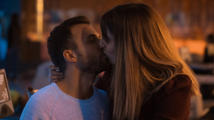 Fototapeta premium young couple kissing at the disco
