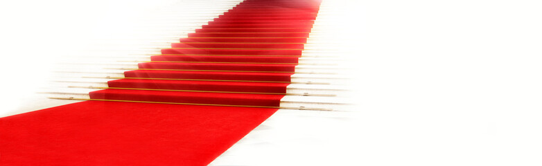 Staircase with red carpet, illuminated by light