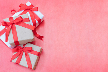 Top view close up three gift boxes. Red ribbon bow with gift boxes on red background, Wrapped vintage box with copy space