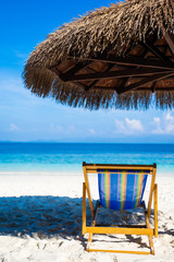 beach chair and wooden beach umbrella
