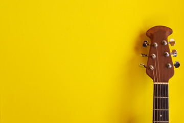 Top view electro acoustic guitar over yellow background. musician guitarist player concept.