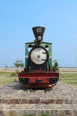 Unused old rusty antique green steam train locomotive front view