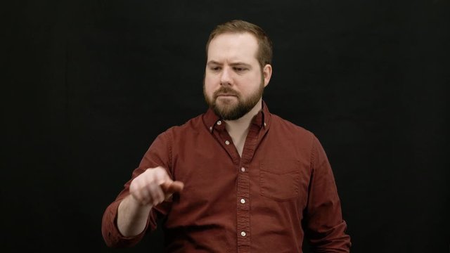 Man expressing emotions on black background