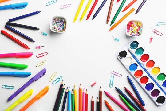 Colorful art supplies arranged in a circle on a white background