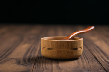Wooden spoon and wooden Cup on wooden table.