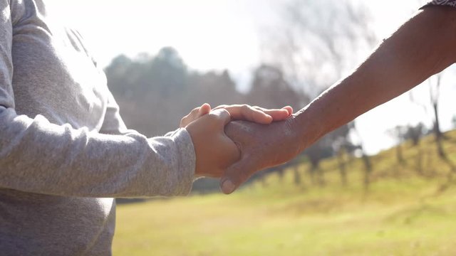 Close-up young lady holding hand comforting upset older man having problem of Health. Concepts of caring for the elderly.