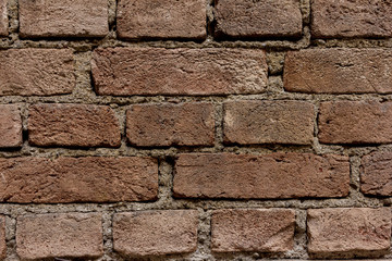 Wall of bricks. Brick worn by time.