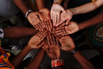 Palms up hands of happy group of multinational African, latin american and european people which...