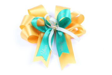 green & yellow color ribbon bow on white background