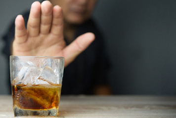 Alcoholism treatment concept.Man refuses to drink a alcohol.