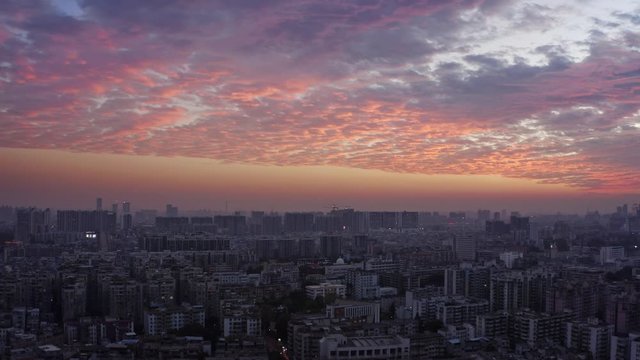 Bird eye view on Guangzhou endless suburb districts during epic red sunset with clouds, China, Guangdong.