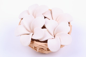 Fototapeta na wymiar Frangipani flower made of ceramic in a bowl isolated on white
