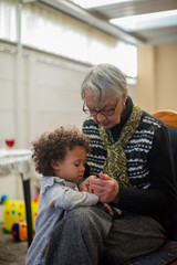 Grandma and grandchild staring at cellphone