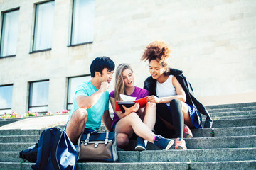 cute group of teenages at the building of university with books huggings, diversity nations real students lifestyle
