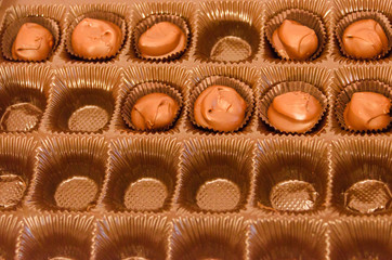 Half empty box of chocolate covered macadamia nuts