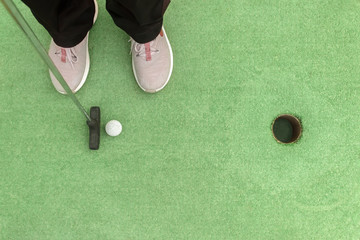 Closing a mini golf hole with the bat and ball