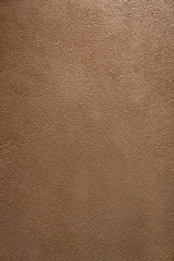 Fototapeta premium Orange stucco material with light illuminated from top / background texture / interior material